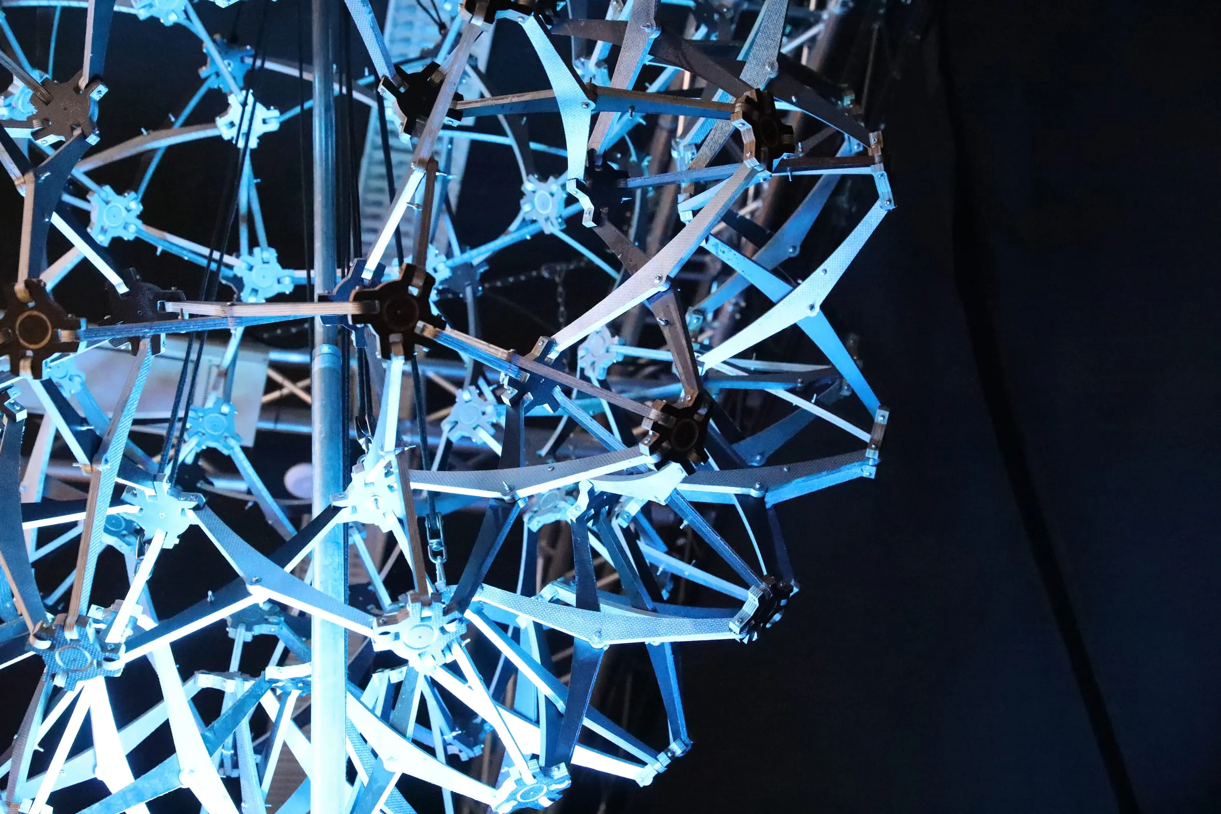 Light Sphere – A suspended sculpture of interlocking metal bands, transforming with every change of light.